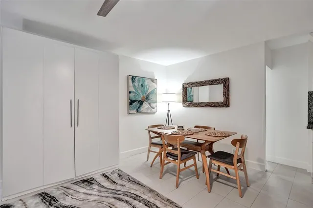 a dining room with furniture and a window