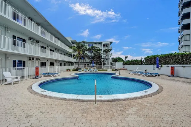 a view of a swimming pool with a patio