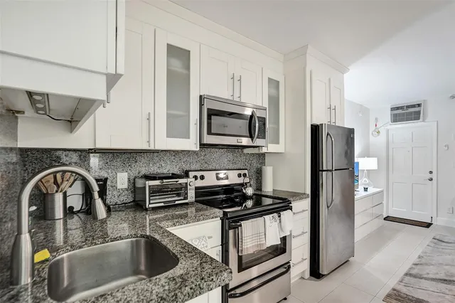 a kitchen with a sink cabinets and stainless steel appliances