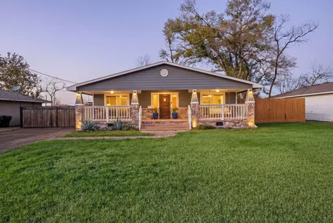 a front view of a house with a garden and porch