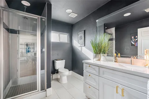 a bathroom with a double vanity sink toilet and shower