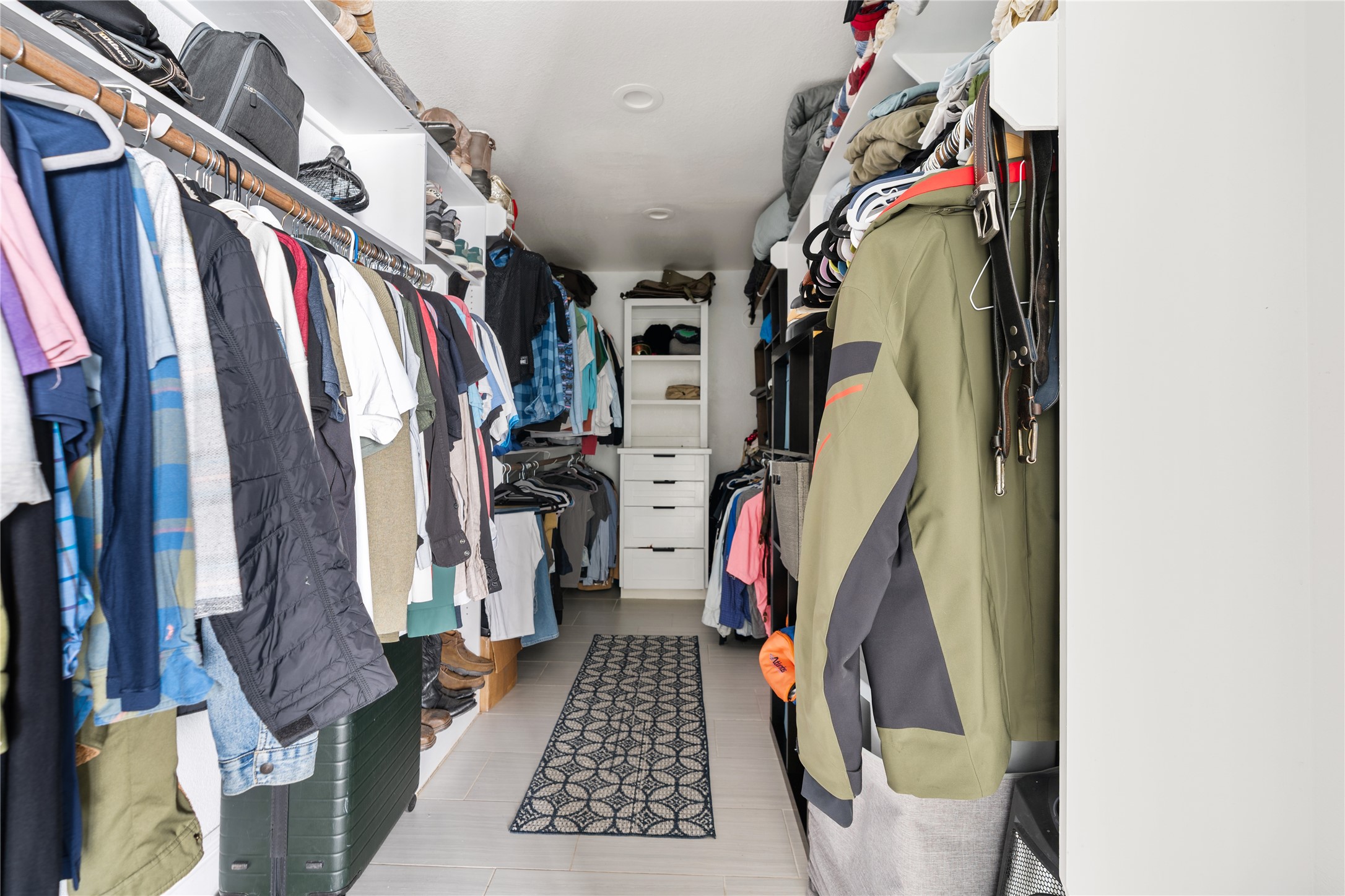 4522 Randwick Drive Houston, TX 77092 - Photo 21 of 32 a view of walk in closet with clothes and shoes