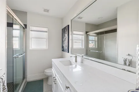 a bathroom with a sink toilet and shower