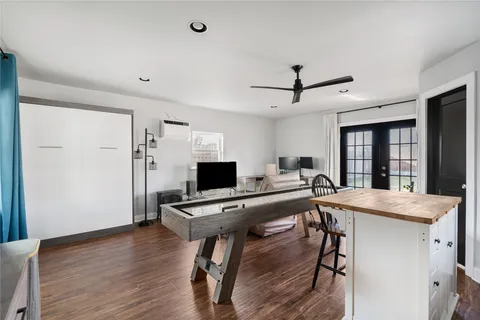 a view of a workspace with furniture and wooden floor