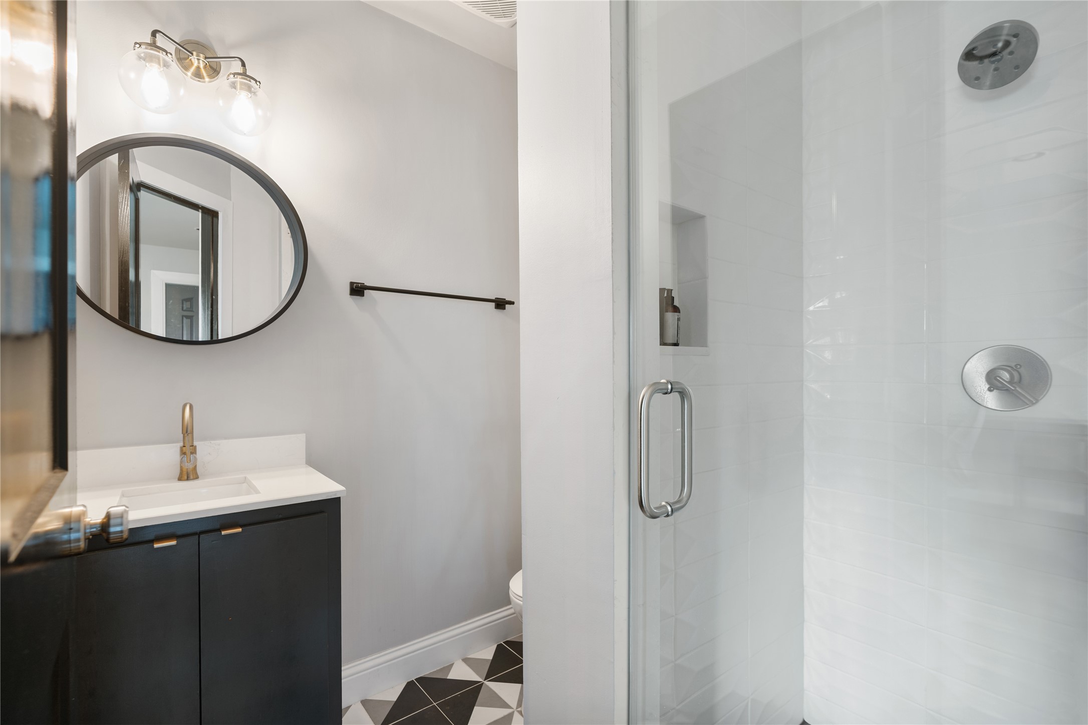 4522 Randwick Drive Houston, TX 77092 - Photo 28 of 32 a bathroom with a sink and mirror