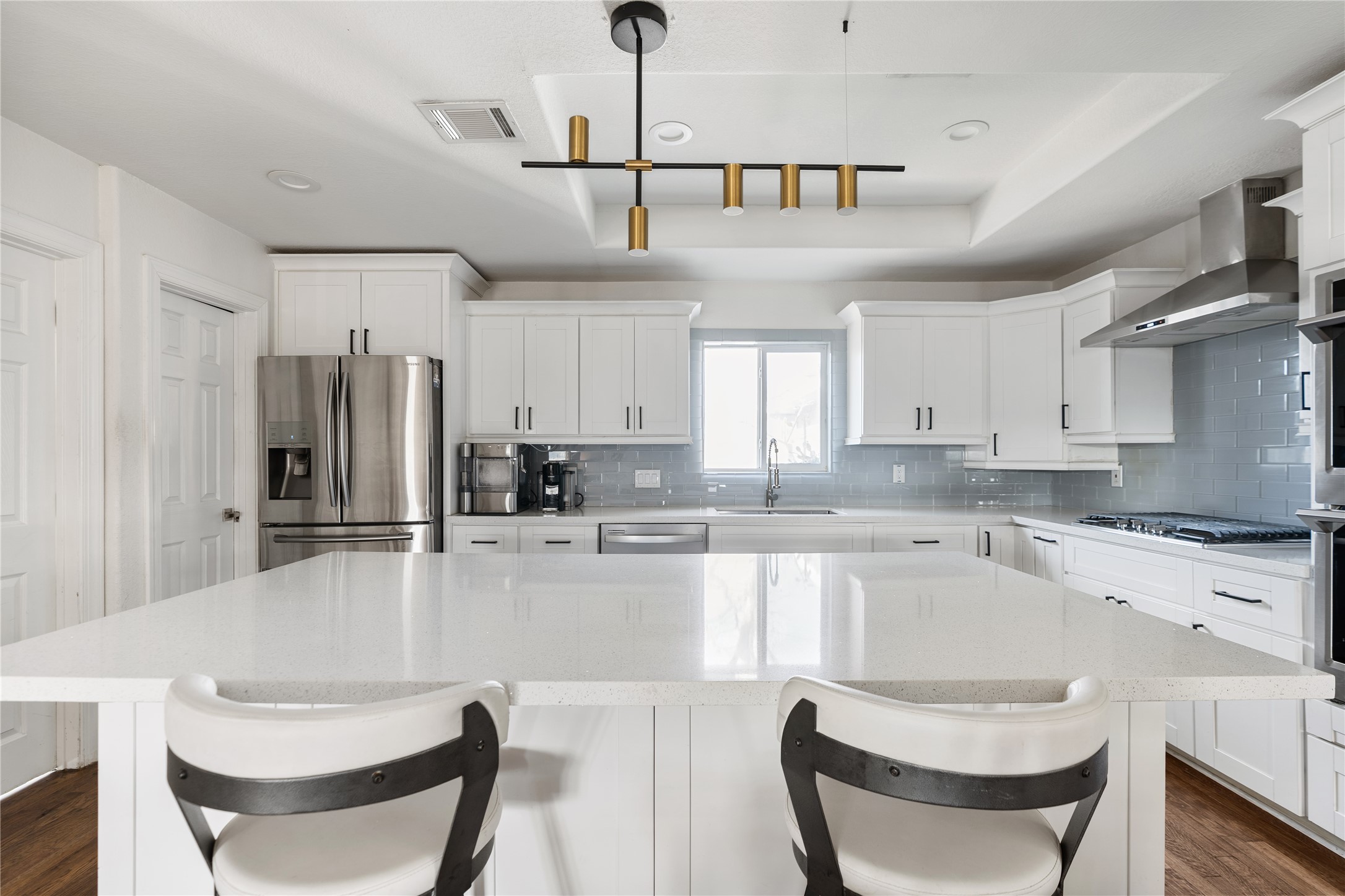 4522 Randwick Drive Houston, TX 77092 - Photo 7 of 31 The kitchen anchors the home with quartz countertops and a generous center island. A walk-in pantry offers additional convenience.