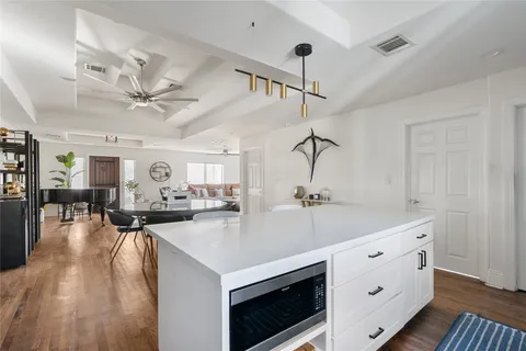 a kitchen with sink stove and cabinets