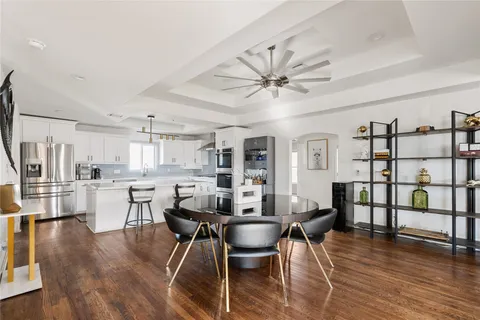 a view of a dining room with furniture and wooden floor