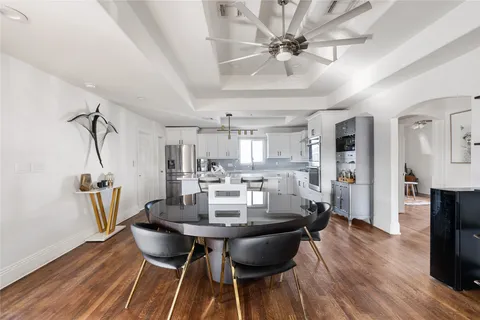 a view of a dining room with furniture and wooden floor