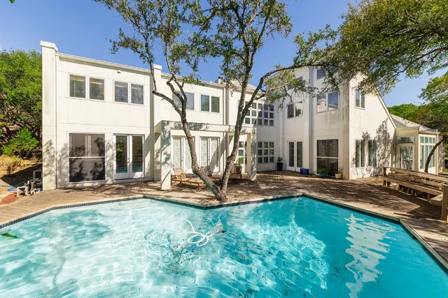 a view of a house with backyard porch and sitting area