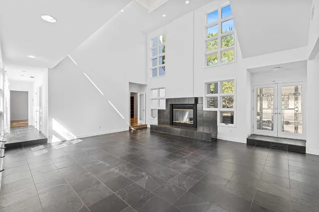 a view of an empty room with a fireplace and a window