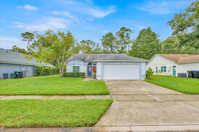a front view of a house with a yard and garage