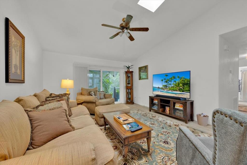 5734 Delano Lane Orlando, FL 32821 - Photo 12 of 28 a living room with furniture a window and a flat screen tv
