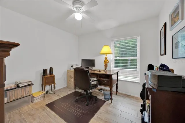 a view of a workspace with furniture and a window
