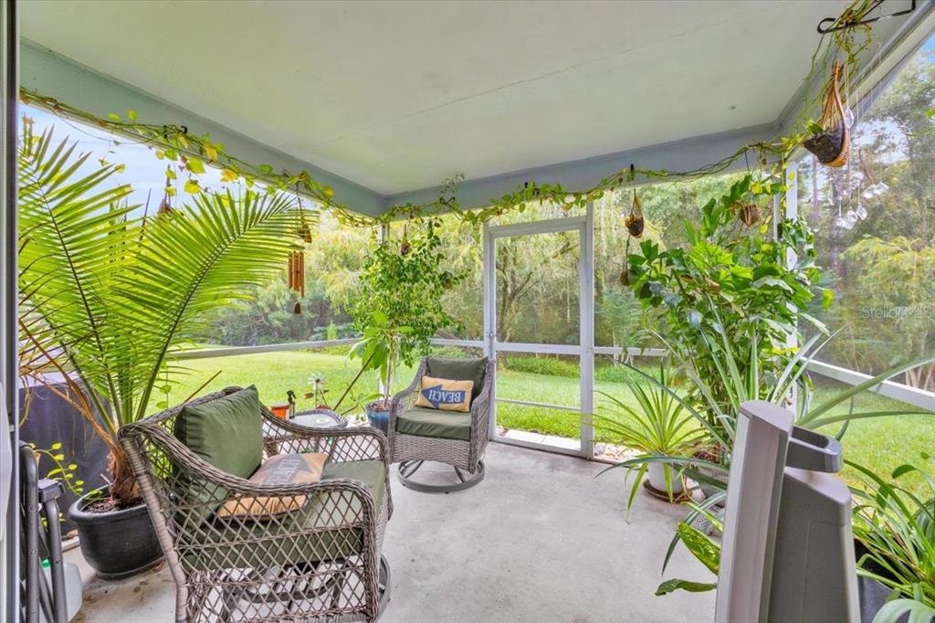 5734 Delano Lane Orlando, FL 32821 - Photo 21 of 28 a view of a porch with furniture and a yard