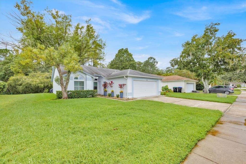 5734 Delano Lane Orlando, FL 32821 - Photo 3 of 28 a front view of a house with a garden