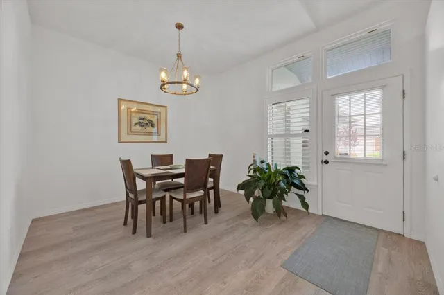 a view of a dining room with furniture and chandelier