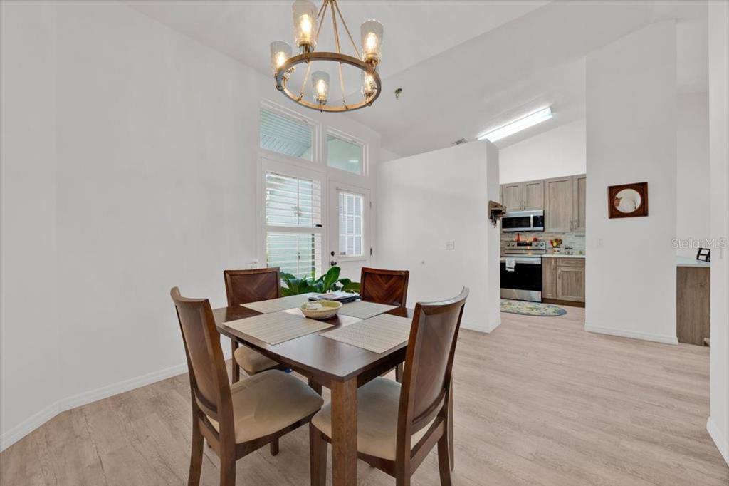 5734 Delano Lane Orlando, FL 32821 - Photo 6 of 28 a view of a dining room with furniture and wooden floor