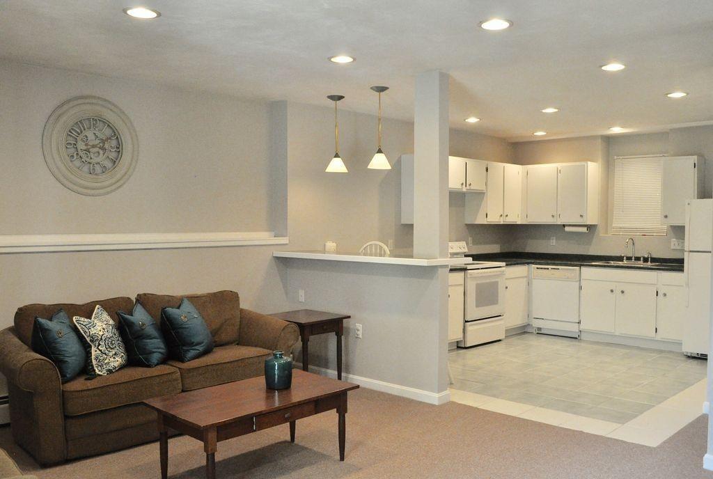 171 County Road Bourne, MA 02532 - Photo 11 of 27 a living room with granite countertop a couch and a view of kitchen