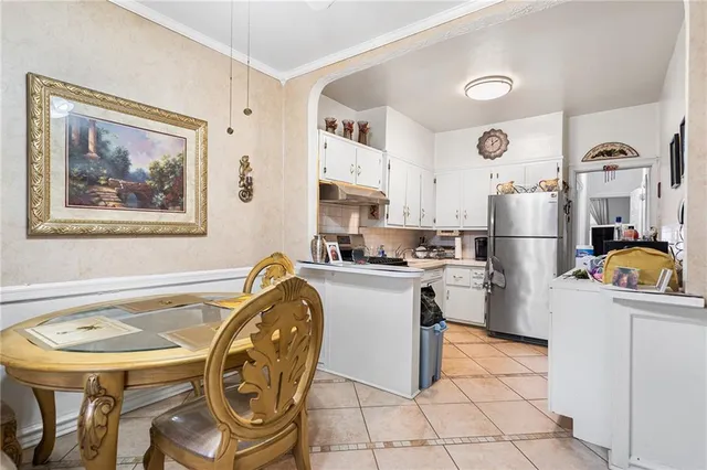 a kitchen with a sink a refrigerator and a stove top oven