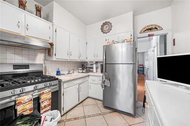 a kitchen with a stove cabinets and window