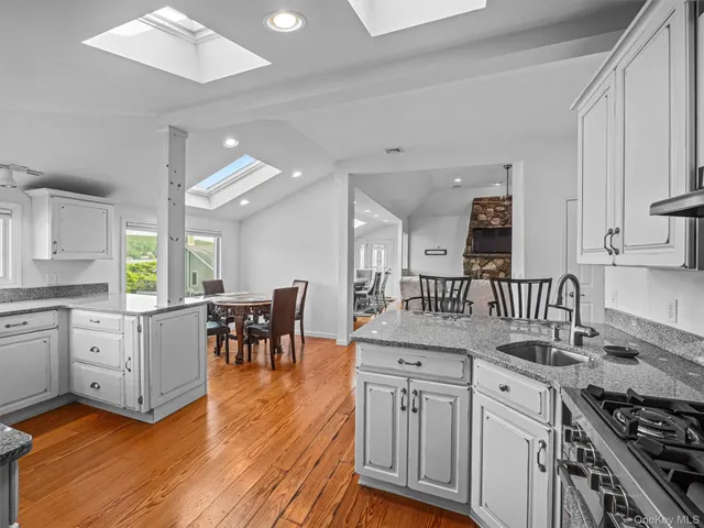 a kitchen with appliances cabinets and a large window