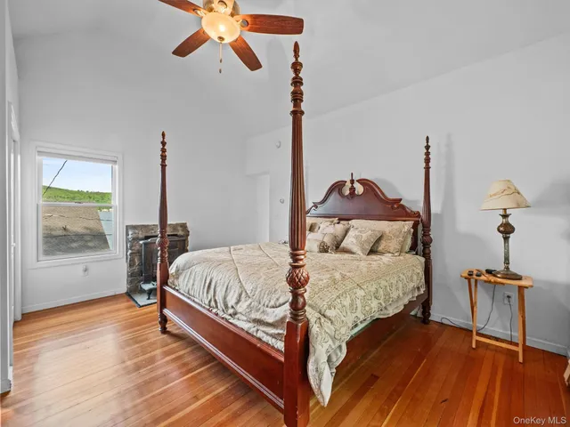 a living room with furniture a flat screen tv and next to a window