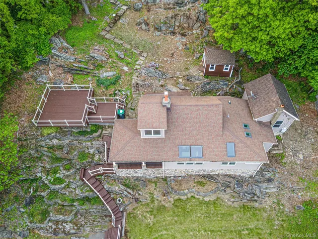 a bathroom with a granite countertop sink a large mirror a toilet and a shower