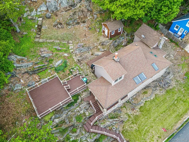 an aerial view of a house with a yard and trees