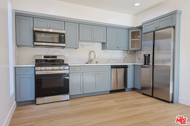 a kitchen with a sink stove and refrigerator