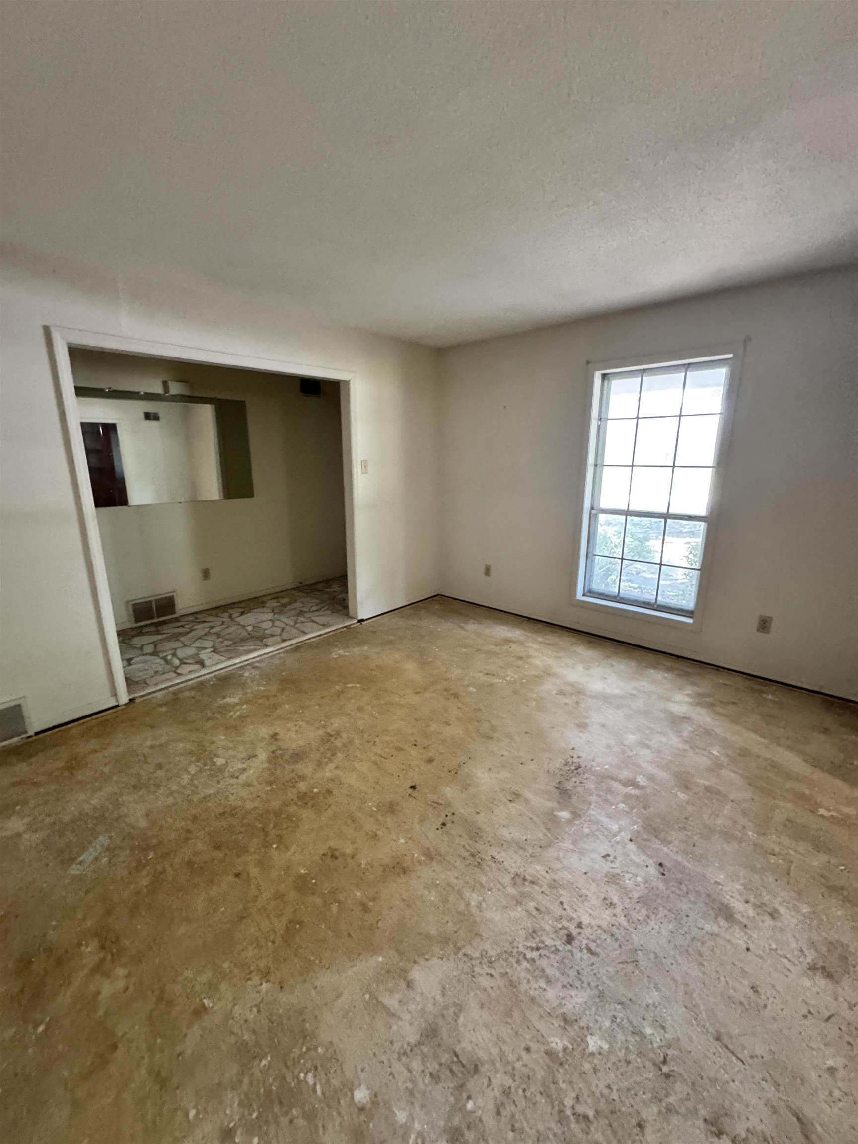5520 Wagon Rd Gap, Unit GAP Memphis, TN 38134 - Photo 5 of 19 Living area featuring a large window, neutral wall tones, and an open doorway to an adjoining room with patterned flooring