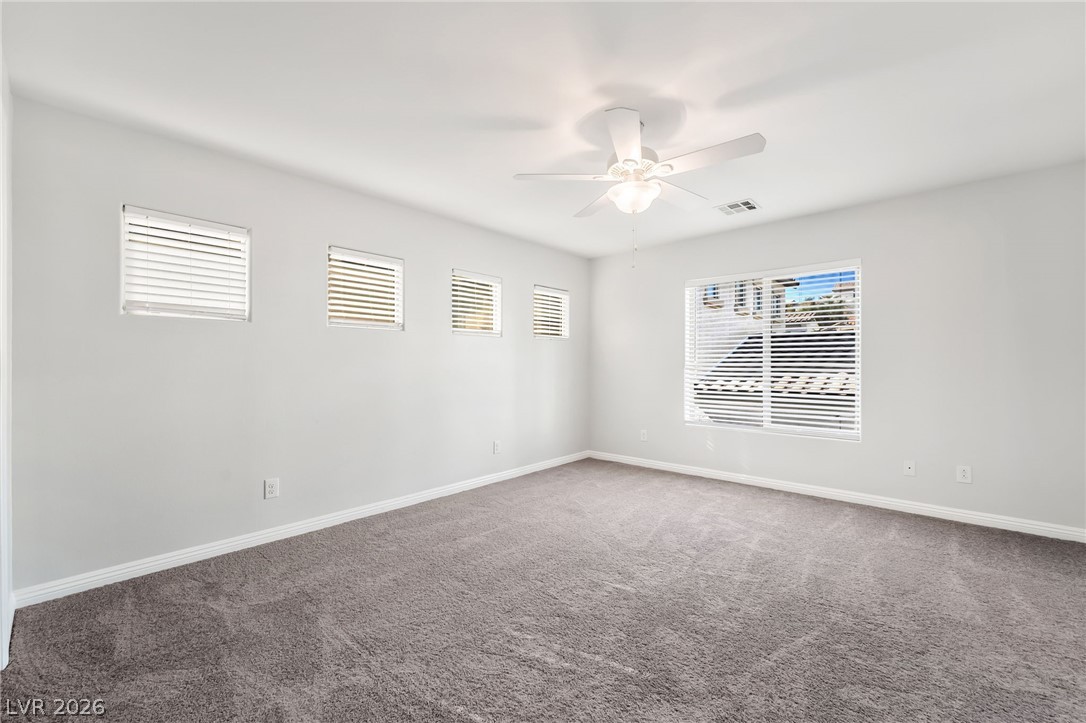 33 Jasmine Point Street Henderson, NV 89074 - Photo 16 of 36 Carpeted spare room featuring baseboards and a ceiling fan
