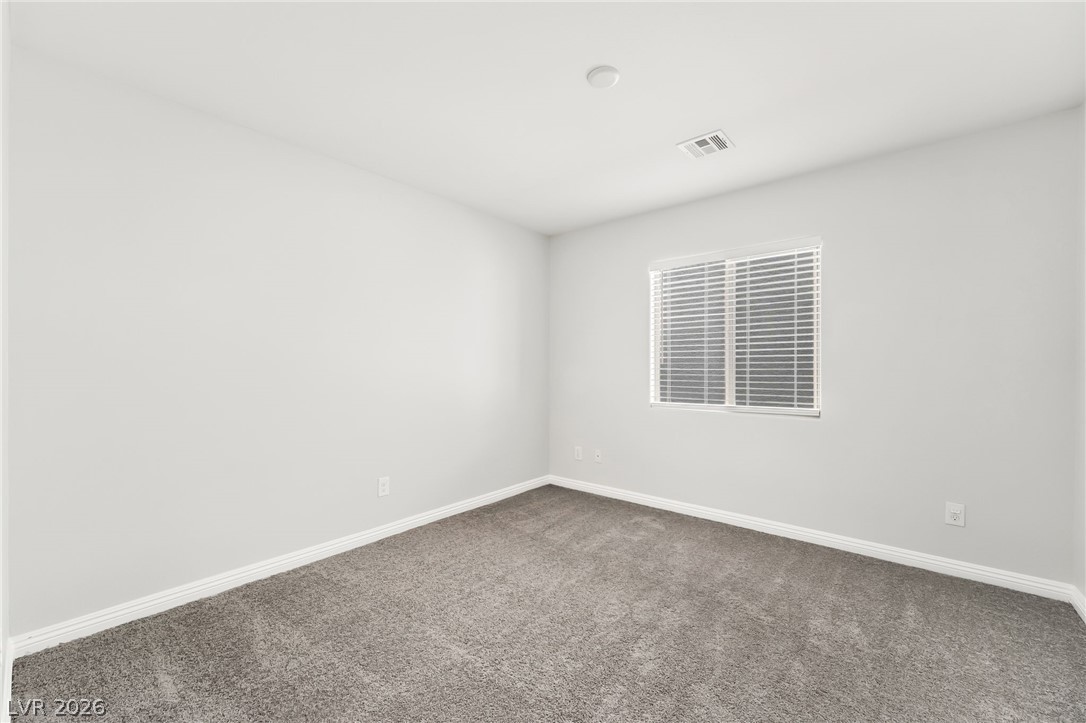 33 Jasmine Point Street Henderson, NV 89074 - Photo 24 of 36 Carpeted spare room featuring baseboards