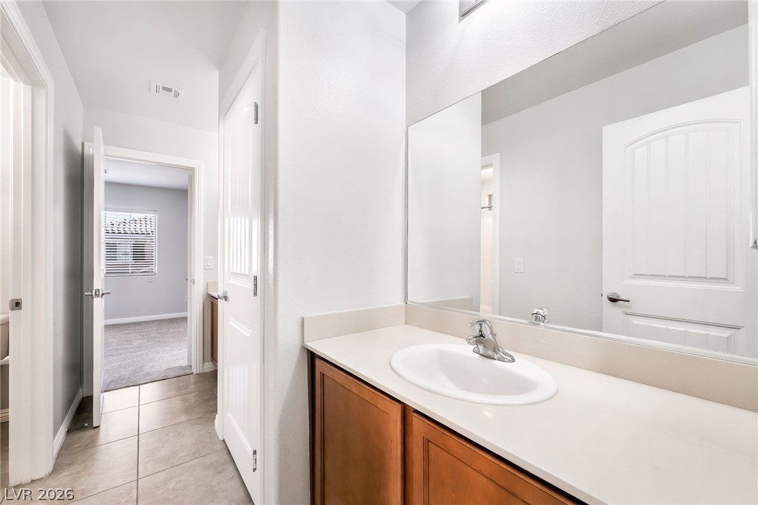 33 Jasmine Point Street Henderson, NV 89074 - Photo 26 of 36 Bathroom with vanity and light tile patterned flooring