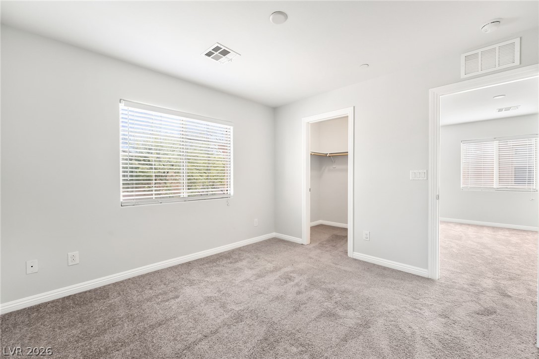 33 Jasmine Point Street Henderson, NV 89074 - Photo 29 of 36 Unfurnished bedroom featuring a spacious closet and light carpet