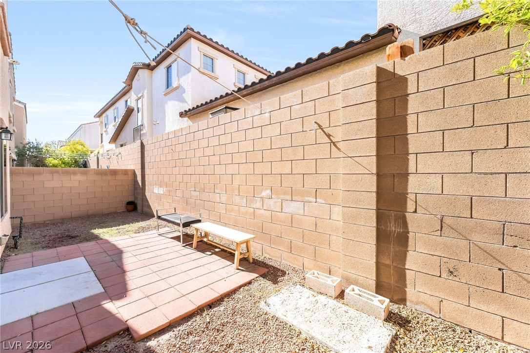 33 Jasmine Point Street Henderson, NV 89074 - Photo 31 of 36 Fenced backyard with a patio