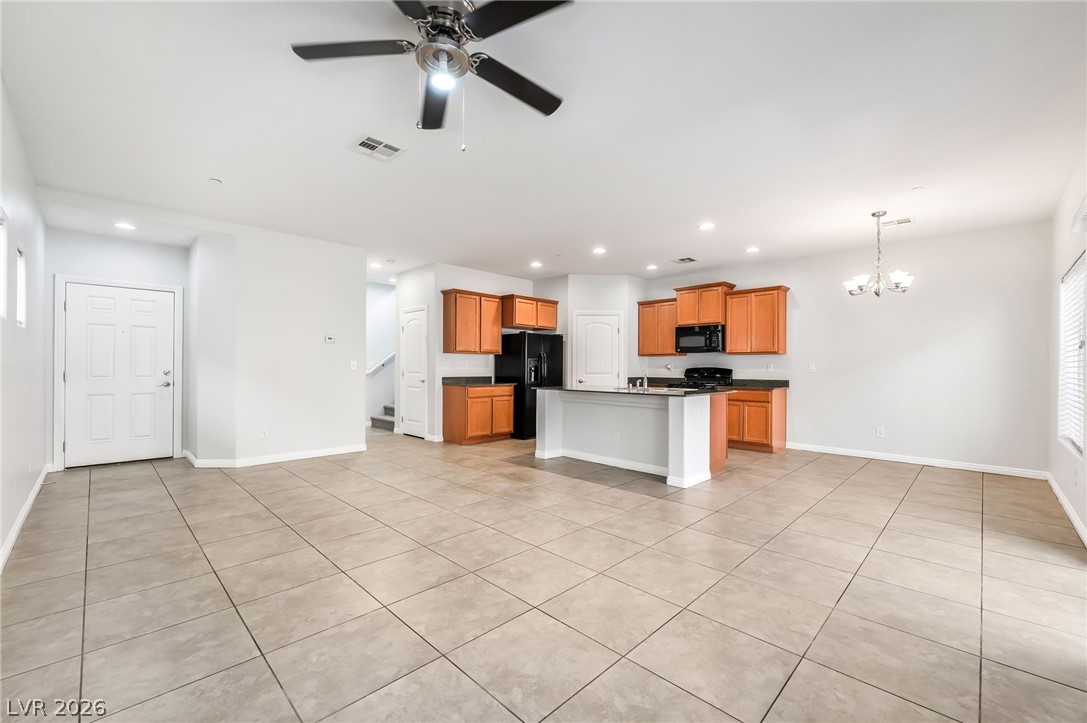 33 Jasmine Point Street Henderson, NV 89074 - Photo 35 of 36 Kitchen featuring dark countertops, hanging lights, open floor plan, a ceiling fan, and an island with sink