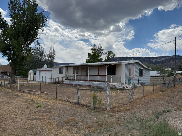 210 South State Street Moroni, UT 84646 - Photo 18 of 23 Single-story residence featuring a covered front porch with white railings