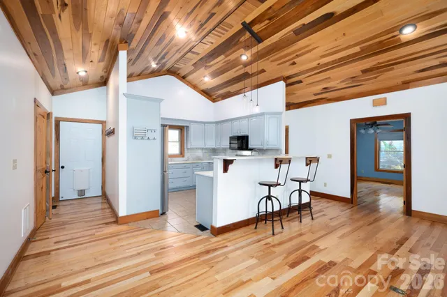 a view of a dining room with furniture wooden floor and a chandelier