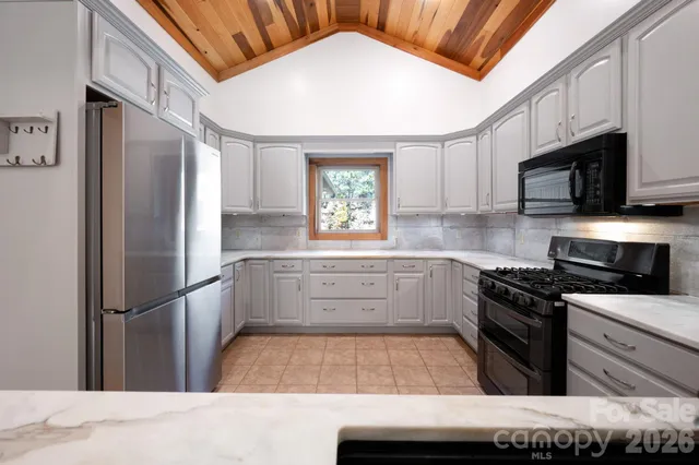 a kitchen with a refrigerator stove and microwave