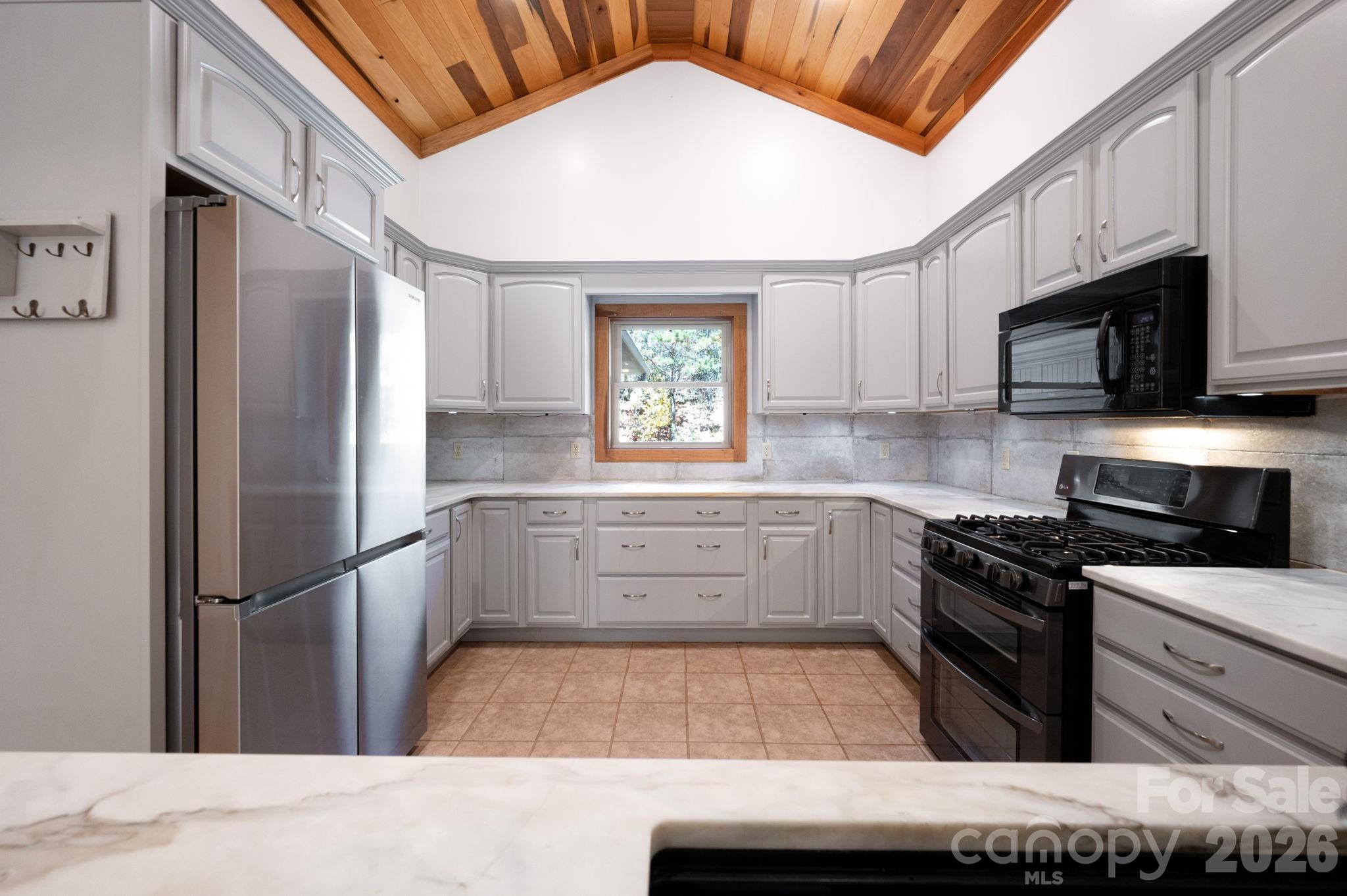 22 Faholoa Ridge Road Black Mountain, NC 28711 - Photo 14 of 47 a kitchen with a refrigerator stove and microwave