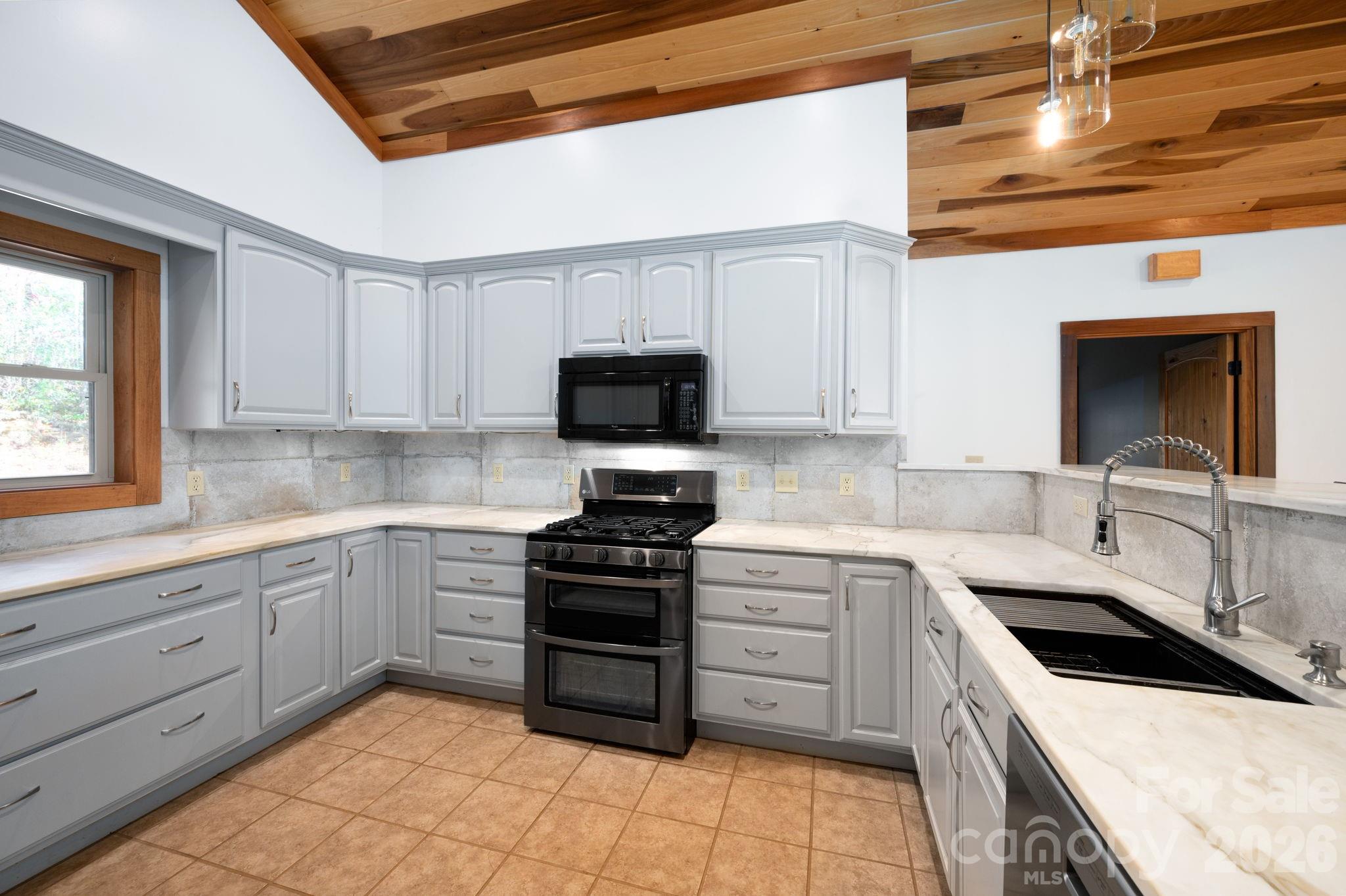 22 Faholoa Ridge Road Black Mountain, NC 28711 - Photo 24 of 47 a kitchen with a sink stove and microwave