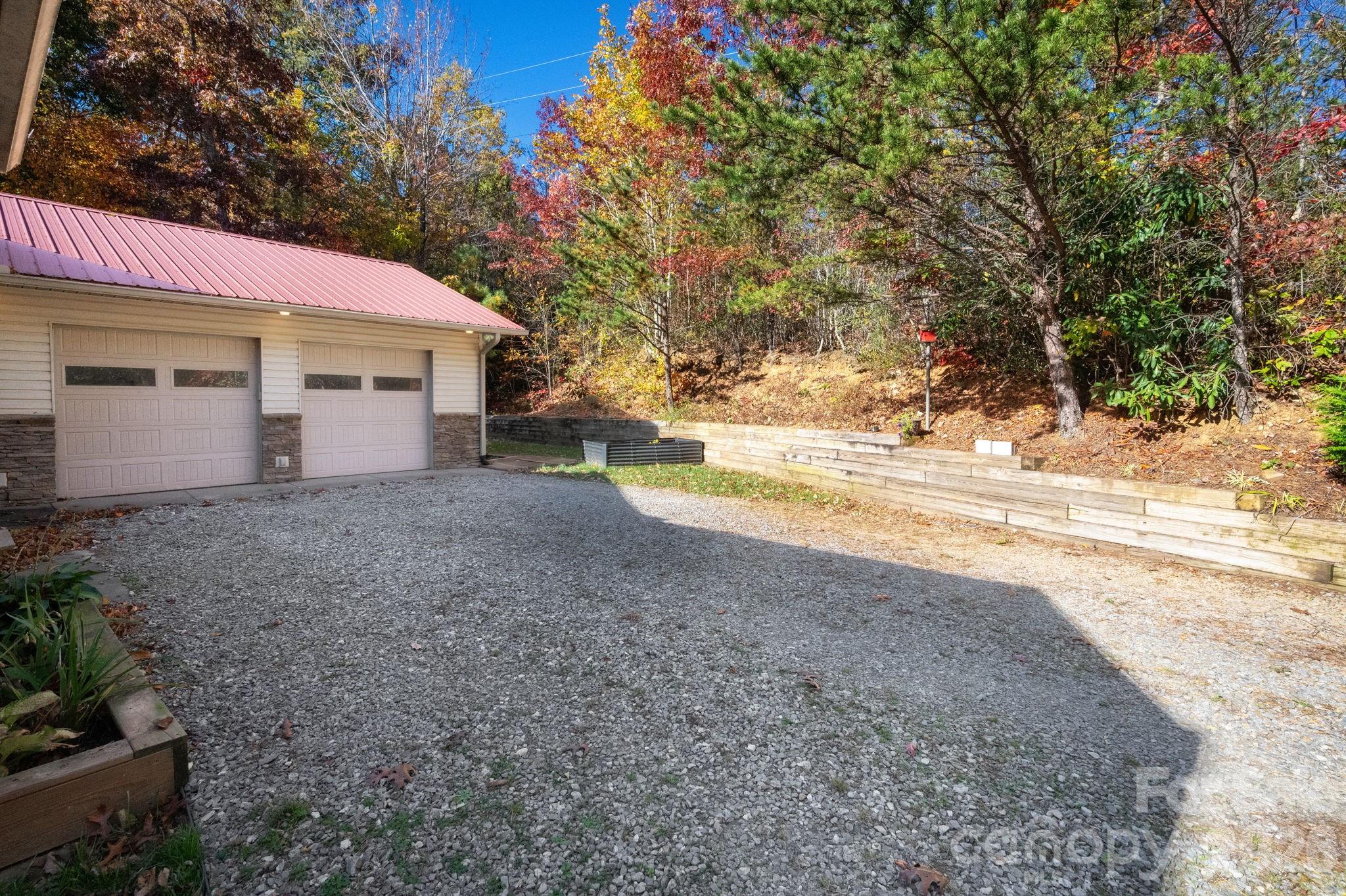 22 Faholoa Ridge Road Black Mountain, NC 28711 - Photo 44 of 47 a view of a house with a yard and garage