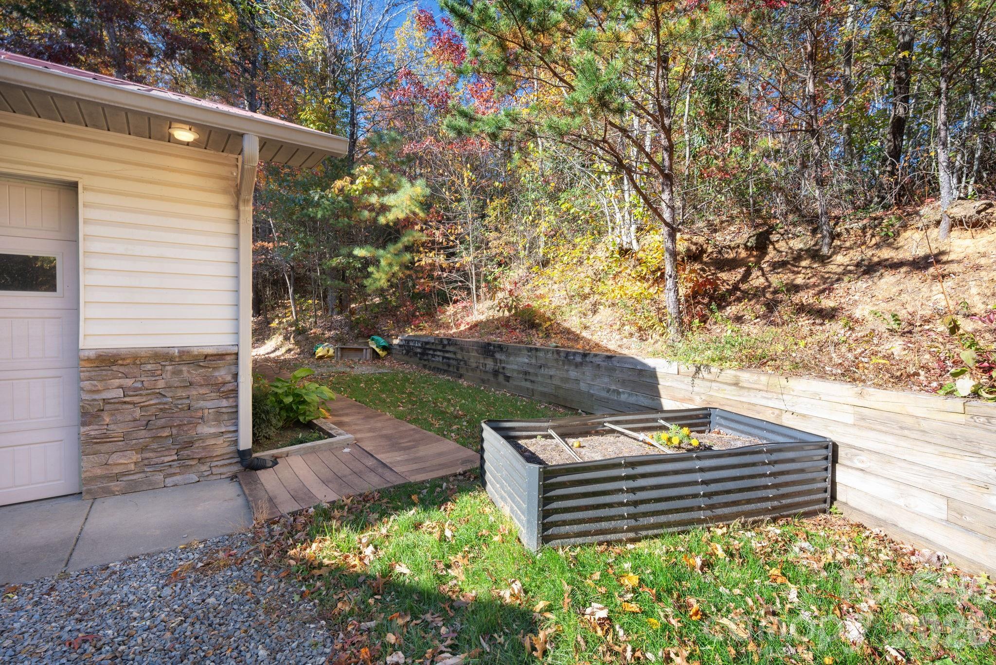 22 Faholoa Ridge Road Black Mountain, NC 28711 - Photo 45 of 47 a view of a wooden bench sitting in backyard