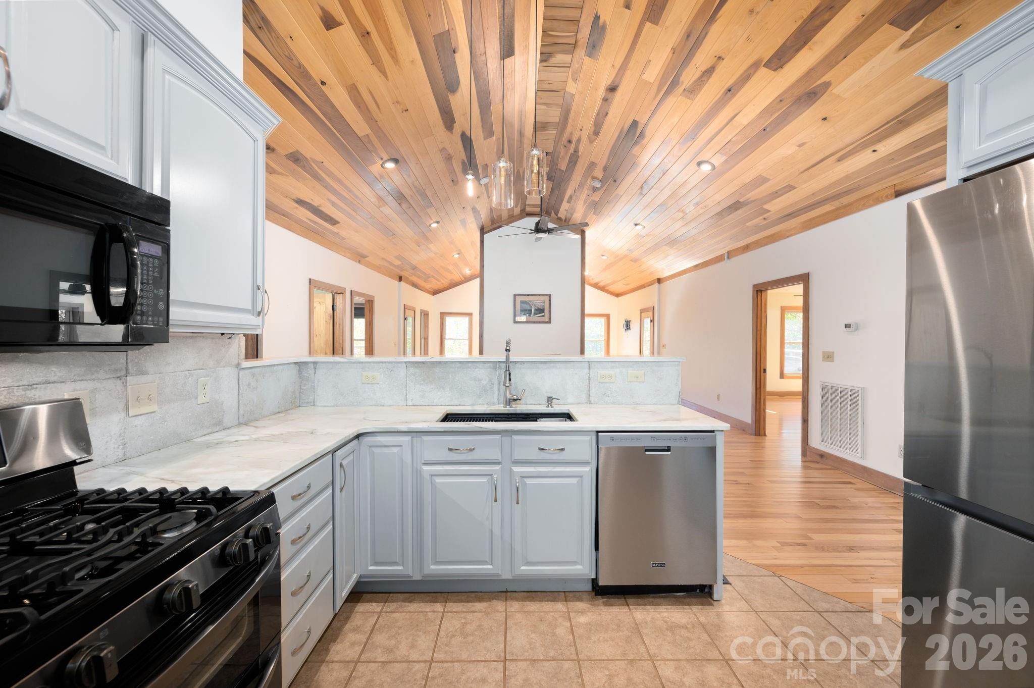 22 Faholoa Ridge Road Black Mountain, NC 28711 - Photo 7 of 47 a kitchen with a stove sink and cabinets