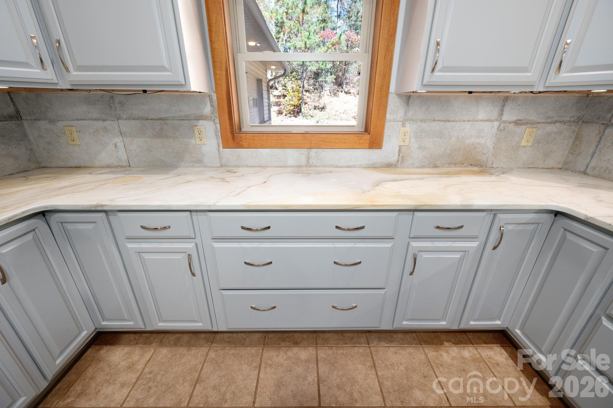 22 Faholoa Ridge Road Black Mountain, NC 28711 - Photo 8 of 47 a kitchen with granite countertop white cabinets and sink