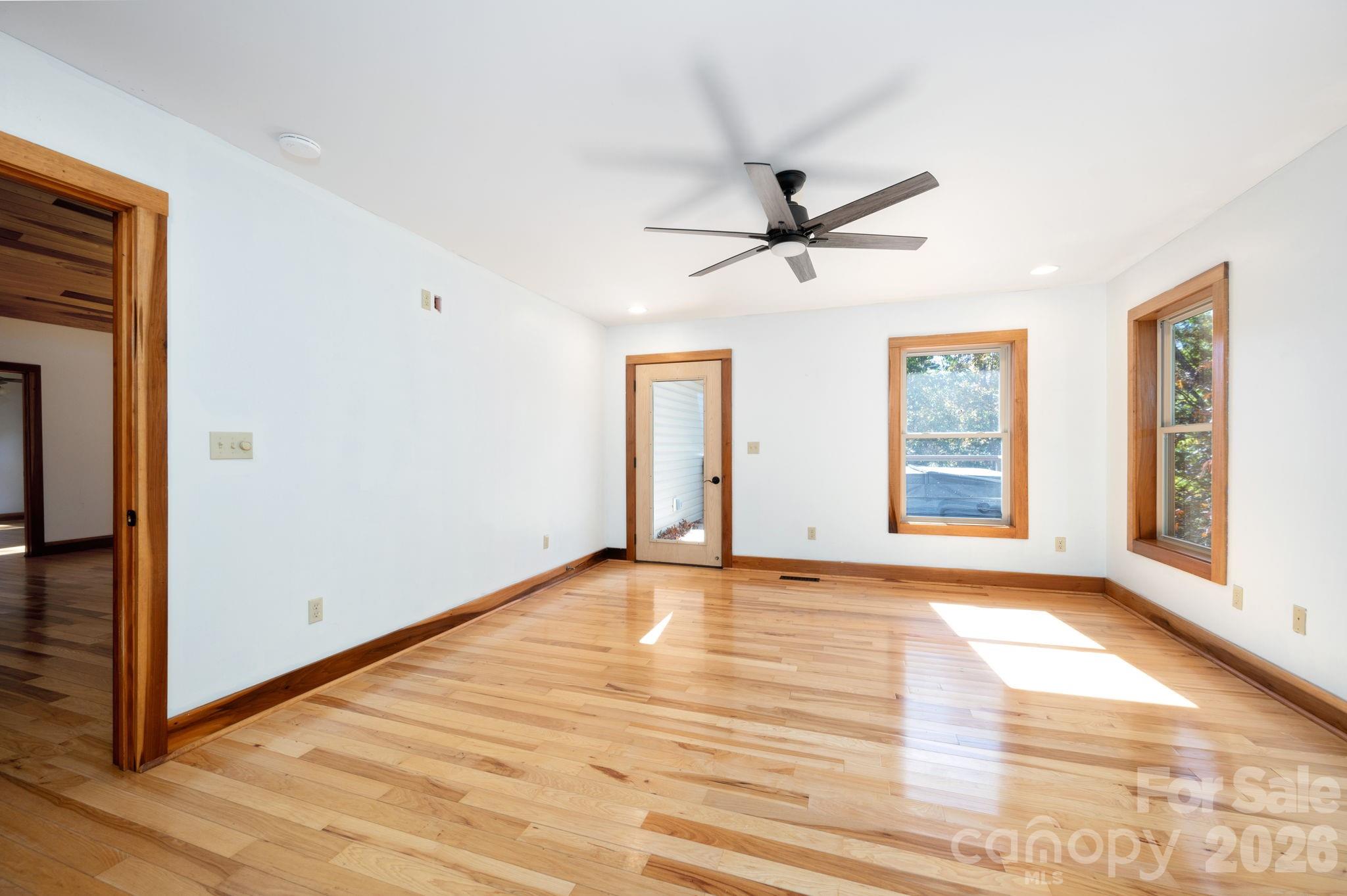 22 Faholoa Ridge Road Black Mountain, NC 28711 - Photo 9 of 47 a view of an empty room with a window and wooden floor