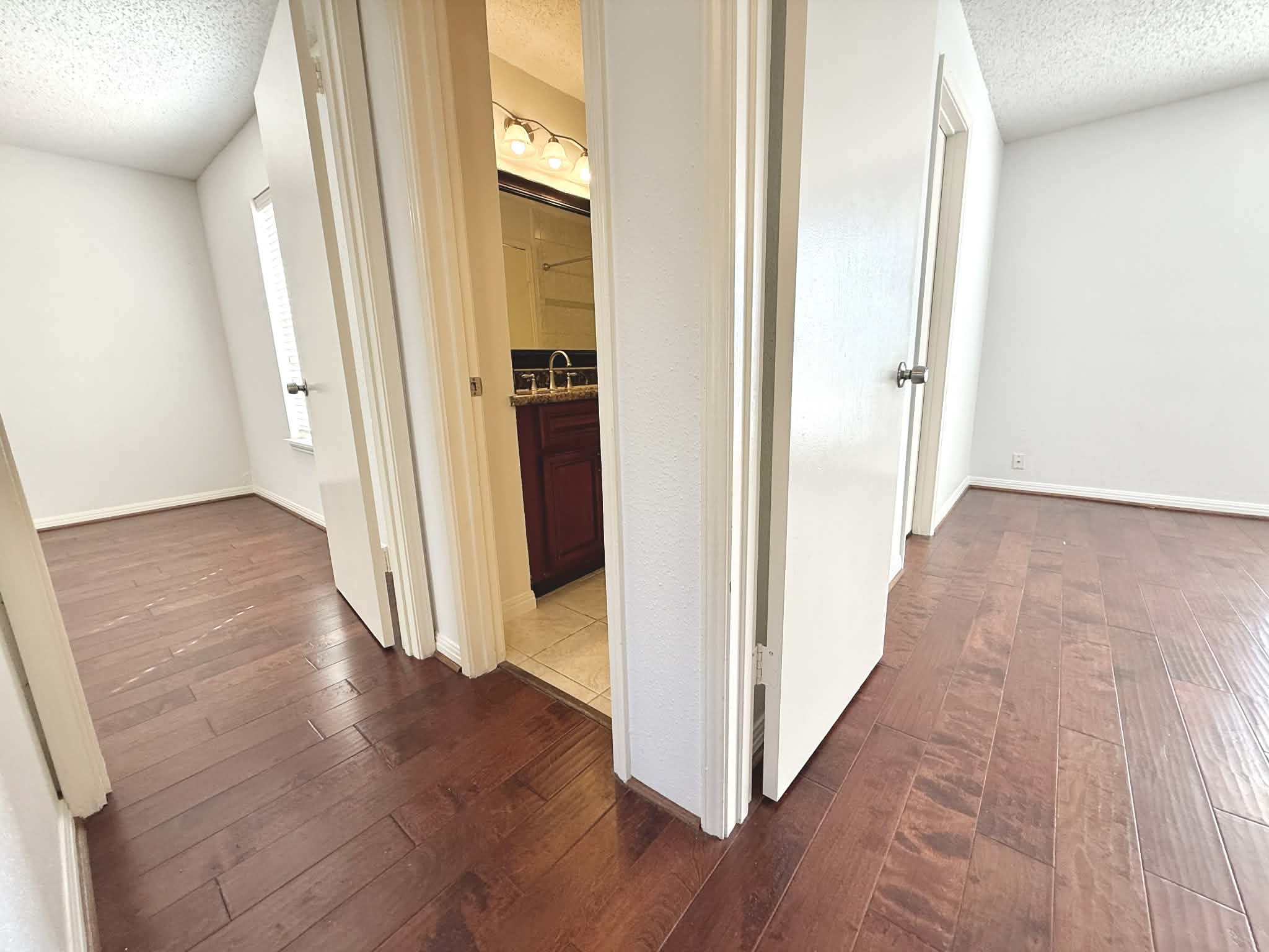 12100 Overbrook Lane, Unit 17D Houston, TX 77077 - Photo 11 of 22 a view of a hallway with wooden floor