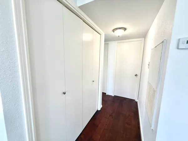 a view of a hallway with a wooden floor