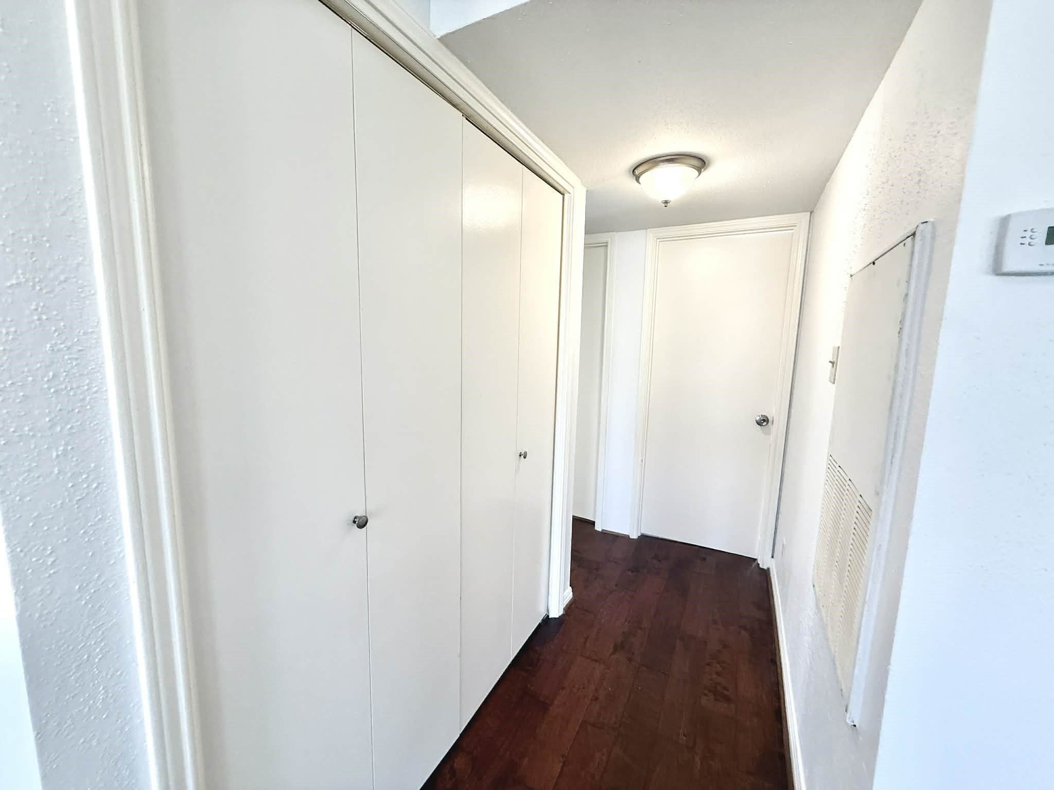 12100 Overbrook Lane, Unit 17D Houston, TX 77077 - Photo 12 of 22 a view of a hallway with a wooden floor